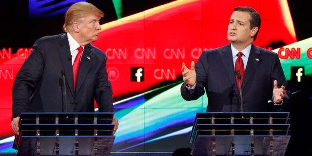 In this Dec. 15, 2015 photo, Donald Trump, left, watches as Ted Cruz speaks during the CNN Republican presidential debate at the Venetian Hotel & Casino in Las Vegas. A growing debate over Americaâs role in promoting regime change in the Middle East is creating unusual alliances among 2016 presidential candidates that cross party lines. (AP Photo/John Locher)