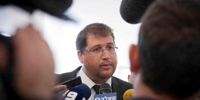 In this Tuesday, Dec. 17, 2013 photo, Israeli lawyer Michael Sfard talks to media after a court hearing at Israel's Supreme Court in Jerusalem. Sfard has emerged as one of the most effective defenders of Palestinian rights, arguing and winning high-profile cases in Israel's Supreme Court. Major victories include forcing the government to dismantle a large rogue settlement in the West Bank and rerouting Israel's separation barrier along some stretches to restore farmland to Palestinian villages. (AP Photo/Dan Balilty)