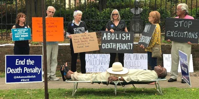 Pulaski County Circuit Judge Wendell Griffen, lying on cot, takes part in an anti-death penalty demonstration outside the Governor's Mansion in Little Rock, Ark., in April 2017. (Cheryl Simon via AP)