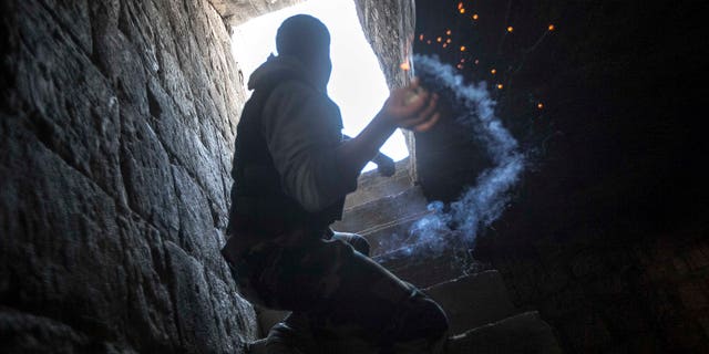 Nov. 04, 2012: A rebel fighter prepares to throw a homemade grenade toward Syrian troops loyal to President Bashar Assad who are hiding in a nearby building as they attempt to gain ground against rebel lines during heavy clashes in the Jedida district of Aleppo, Syria.