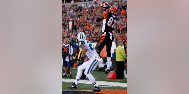 Cincinnati Bengals wide receiver Marvin Jones (82) catches a nine-yard touchdown pass against New York Jets cornerback Dee Milliner (27) in the first half of an NFL football game, Sunday, Oct. 27, 2013, in Cincinnati. (AP Photo/David Kohl)