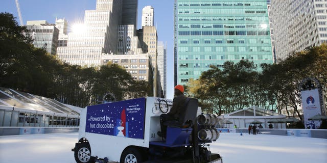 The ice rink at Bryant Park in New York is resurfaced on Sunday, Nov. 10, 2013. A shooting at the ice rink at the popular midtown Manhattan park late Saturday sent two men to the hospital with non-life-threatening injuries, police said. (AP Photo/Peter Morgan)