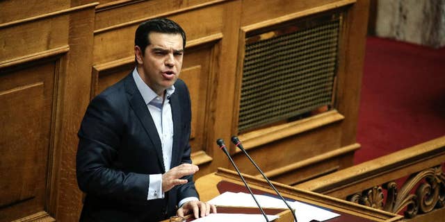 Greece's Prime Minister Alexis Tsipras addresses lawmakers during a parliamentary session in Athens, Saturday, Dec. 10, 2016. Greek parliament votes on 2017 budget, as the country's left-wing government is still negotiating a new series of cost-cutting reforms that are expected to remove protection measures for private sector jobs and distressed mortgage holders. (AP Photo/Yorgos Karahalis)