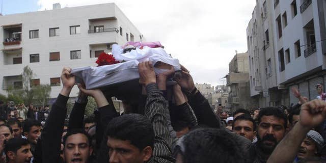 AP/citizen journalism image/Protesters carry the coffin of an activist who was killed