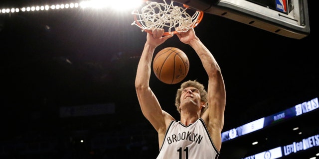 Brooklyn Nets center Brook Lopez dunks during the second half of the Nets' NBA basketball game against the Los Angeles Lakers, Sunday, March 29, 2015, in New York. The Nets won 107-99. (AP Photo/Mary Altaffer)