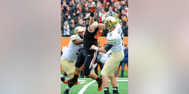 Oregon State's Mana Rosa (93) deflects a throw by Colorado quarterback Connor Wood (5) in the first half of an NCAA college football game on Saturday, Sept 28, 2013, in Corvallis, Ore. (AP Photo/Greg Wahl-Stephens)