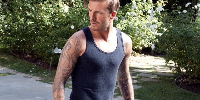 This October 2012 photo released by H & M shows soccer star David Beckham on the set of his newest ad campaign for his bodywear collection in Los Angeles. The ad is more like a film short, directed by Guy Ritchie. Beckham stars as an action hero, saving the day in Los Angeles in his boxer briefs and bedroom slippers. (AP Photo/H&M)