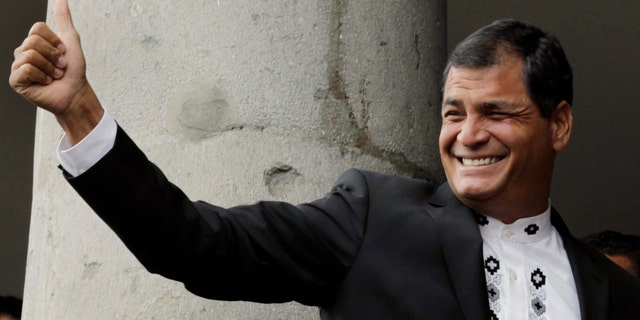 FILE - In this Feb. 16, 2013 file photo, Ecuador's President Rafael Correa gives a thumbs up to supporters as he stands with the Emir of Qatar Sheikh Hamad bin Khalifa al-Thani, not in picture, on a balcony at the government palace in Quito, Ecuador. On Friday, May 24, 2013, Correa will begin his second presidential term after winning the Feb. 17 election. (AP Photo/Dolores Ochoa, File)