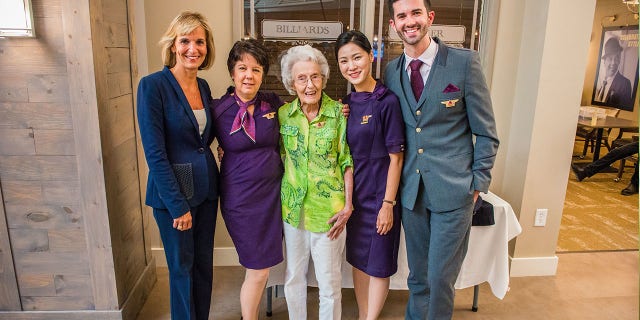 Surrounded by family, friends and airline staffers, Harmon was presented with an orchid and pinned with a new set of flight attendant wings