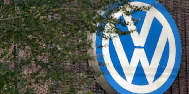 FILE - In this Sept. 26, 2015 file photo, trees stand in front of a giant logo of the German car manufacturer Volkswagen in Wolfsburg, Germany. German automaker Volkswagen is reporting better-than-expected operating earnings for the first quarter thanks to cost controls and a stronger contribution from its core brand, which was boosted by new models including the Tiguan SUV the company said Tuesday, April 18, 2017. (AP Photo/Michael Sohn,file)