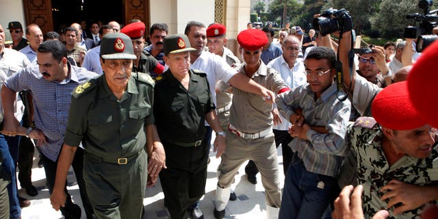 Sept. 16, 2011: Egypt's military ruler field marshal Mohammed Hussein Tantawi, left, and Sami Anan Egyptian chief of staff of the armed forces, are surrounded by military policemen and cameramen, in Cairo, Egypt.