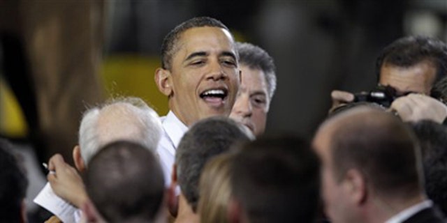 Jan. 25, 2012: President Obama is greeted after speaking about manufacturing jobs, at the Conveyor Engineering &amp; Manufacturing plant, in Cedar Rapids, Iowa.