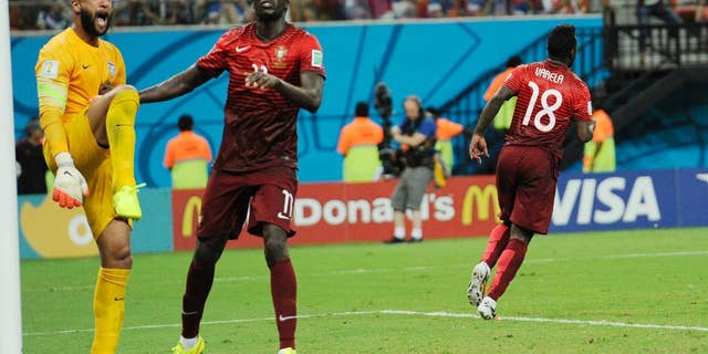 United States' goalkeeper Tim Howard, left, stands near the post as he reacts next to Portugal's Eder, second from left, after Portugal's Silvestre Varela, right, scored the equaliser during the group G World Cup soccer match between the USA and Portugal at the Arena da Amazonia in Manaus, Brazil, Sunday, June 22, 2014. (AP Photo/Paulo Duarte)