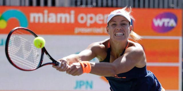 FILE - In this March 27, 2017, file photo, Angelique Kerber, of Germany, hits a return to Risa Ozaki during the Miami Open tennis tournament in Key Biscayne, Fla. Kerber is back at No. 1, replacing the pregnant Serena Williams atop the WTA rankings. Monday's May 15, 2017,  move up from No. 2 represents Kerber's third stay to the top spot, for a total of 26 weeks.(AP Photo/Lynne Sladky, File)