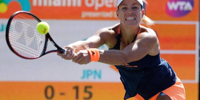 FILE - In this March 27, 2017, file photo, Angelique Kerber, of Germany, hits a return to Risa Ozaki during the Miami Open tennis tournament in Key Biscayne, Fla. Kerber is back at No. 1, replacing the pregnant Serena Williams atop the WTA rankings. Monday's May 15, 2017, move up from No. 2 represents Kerber's third stay to the top spot, for a total of 26 weeks.(AP Photo/Lynne Sladky, File)