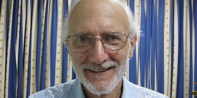 In this file photo provided by U.S. lawyer James L. Berenthal, jailed American Alan Gross poses for a photo during a visit by Rabbi Elie Abadie and Berenthal at Finlay military hospital in Havana, Cuba.