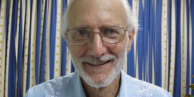 In this file photo provided by U.S. lawyer James L. Berenthal, jailed American Alan Gross poses for a photo during a visit by Rabbi Elie Abadie and Berenthal at Finlay military hospital in Havana, Cuba.