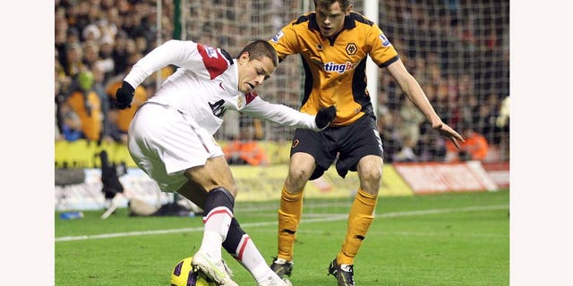 Manchester United's Javier Hernandez, left, competes for the ball with Wolverhampton Wanderers' Richard Stearman during their English Premier League soccer match at the Molineux stadium, Wolverhampton, England, Saturday, Feb. 5, 2011. (AP Photo/Simon Dawson) NO INTERNET/MOBILE USAGE WITHOUT FOOTBALL ASSOCIATION PREMIER LEAGUE (FAPL) LICENCE. CALL +44 (0) 20 7864 9121 or EMAIL info@football-datco.com FOR DETAILS