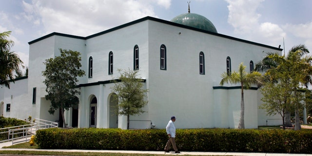 May 14: A pedestrian walks past the Jamat Al-Mummineen Mosque in Margate, Fla., where imam Izhar Khan has been charged with providing about $50,000 in financial support to the Pakistani Taliban.