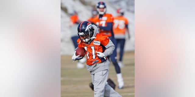Denver Broncos wide receiver Trindon Holliday (11) pulls in a pass during practice for the football team's NFL playoff game against the San Diego Chargers at the Broncos training facility in Englewood, Colo., on Friday, Jan. 10, 2014. Special teams has turned into the Broncos' bugaboo with at least one major mistake in each of the last six games, and Trindon Holliday has had six muffs in the last two months. He also entered last year's playoffs in a prolonged slump and promptly became the first player in league history to return both a punt and a kickoff for touchdowns in the postseason.(AP Photo/Ed Andrieski)