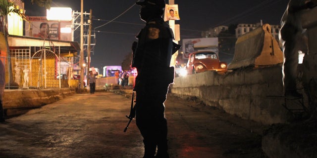 ACAPULCO, MEXICO - MARCH 01: A federal policeman stands guard at the scene of a suspected drug-related execution on March 1, 2012 in Acapulco, Mexico. Drug violence surged in the coastal resort in the last year, making Acapulco the second most deadly city in Mexico after Juarez. One of Mexico's top tourist destinations, Acapulco has suffered a drop in business, especially from foreign tourists, due to reports of the violence. Toursim accounts for some 9 percent of Mexico's economy and about 70 percent of the output of Acapulco's state of Guerrero. (Photo by John Moore/Getty Images)
