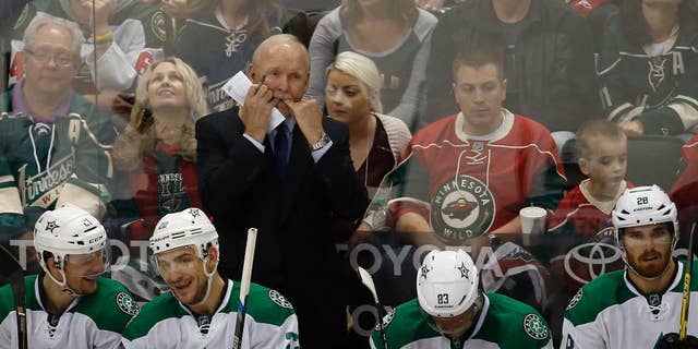 Dallas Stars head coach Lindy Ruff, top, whistles to his players during the second period of Game 6 in the first round of the NHL Stanley Cup playoffs against the Minnesota Wild in St. Paul, Minn., Sunday, April 24, 2016. The Stars won 5-4 to advance to the second round. (AP Photo/Ann Heisenfelt)