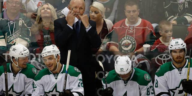 Dallas Stars head coach Lindy Ruff, top, whistles to his players during the second period of Game 6 in the first round of the NHL Stanley Cup playoffs against the Minnesota Wild in St. Paul, Minn., Sunday, April 24, 2016. The Stars won 5-4 to advance to the second round. (AP Photo/Ann Heisenfelt)
