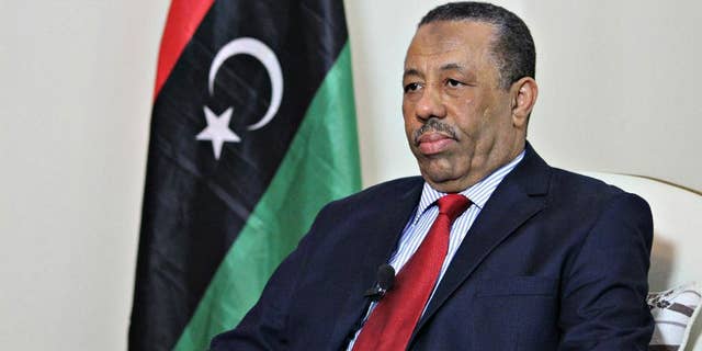In this Wednesday, Aug. 19, 2015 photo, Prime Minister Abdullah al-Thinni listens to a question during an interview with the Associated Press in Bayda, Libya. Libya's internationally-recognized prime minister said Wednesday wants allied countries to carry out airstrikes against local Islamic State affiliates but does not want foreign ground troops, Arab or otherwise. (AP Photo/Ali Al-Shaary)