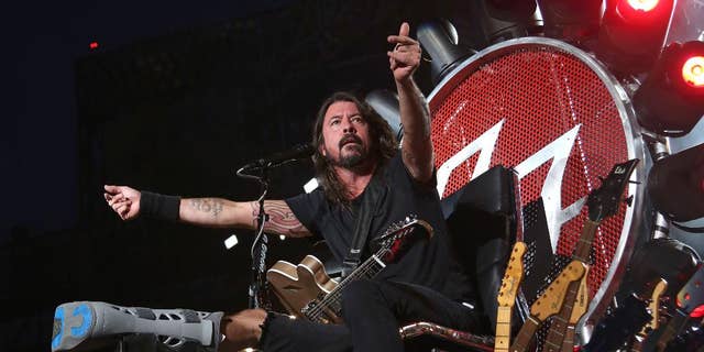 FILE - In this July 15, 2015 file photo, Dave Grohl of the Foo Fighters performs at Citi Field in New York. The band is suing insurers for failing to reimburse them for European shows they canceled following the Paris terrorist attacks in November. (Photo by Greg Allen/Invision/AP, File)
