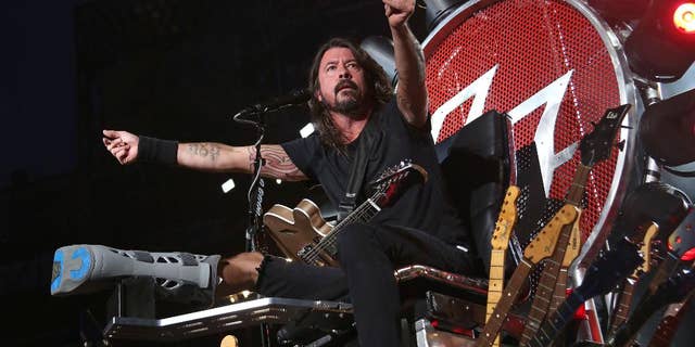 FILE - In this July 15, 2015 file photo, Dave Grohl of the Foo Fighters performs at Citi Field in New York. The band is suing insurers for failing to reimburse them for European shows they canceled following the Paris terrorist attacks in November. (Photo by Greg Allen/Invision/AP, File)