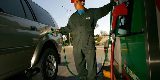 A Pemex gas station attendant filling up a car in Tijuana, Mexico.