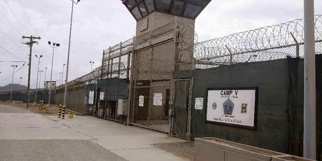 FILE - In this June 7, 2014, file photo, the entrance to Camp 5 and Camp 6 at the U.S. military's Guantanamo Bay detention center, at Guantanamo Bay Naval Base, Cuba. Oman's Foreign Ministry said in a statement Monday, Jan. 16, 2017, it accepted 10 inmates from the U.S. prison at Guantanamo Bay ahead of U.S. President Barack Obama leaving office, part of his efforts to shrink the facility he promised to close. There was no immediate word from the U.S. Defense Department about the transfer. (AP Photo/Ben Fox, File)