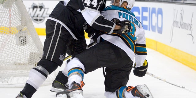 Los Angeles Kings defenseman Robyn Regehr, left, pushes San Jose Sharks center Joe Pavelski off the puck during the third period in Game 7 of the Western Conference semifinals in the NHL hockey Stanley Cup playoffs, Tuesday, May 28, 2013, in Los Angeles. (AP Photo/Mark J. Terrill)
