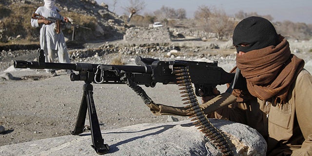 Dec. 13: Taliban fighters man a checkpoint in an undisclosed location east of Kabul, Afghanistan.