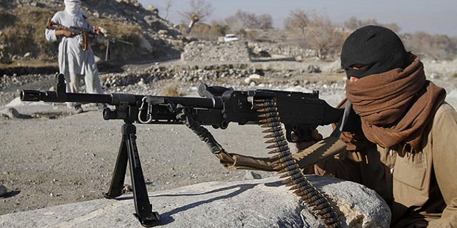 Dec. 13: Taliban fighters man a checkpoint in an undisclosed location east of Kabul, Afghanistan.