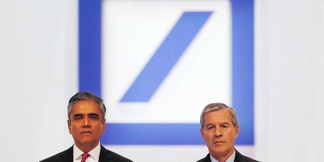 FILE - In this May 22, 2014 file photo Co-CEOs of Deutsche Bank Anshu Jain, left, and Juergen Fitschen pose for photographers during the annual shareholders meeting in Frankfurt, Germany. Deutsche Bank said Sunday, June 7, 2015 that Jain and Fitschen will resign. John Cryan will succeed Jain in July 2015 and will become the sole CEO in May 2016. (AP Photo/Michael Probst, file)