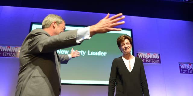 Diane James celebrates with Nigel Farage after being named as the new leader of the UK Independence Party at the party's annual conference in Bournemouth, England, Friday, Sept. 16, 2016. Britain’s right-wing U.K. Independence Party has chosen European Parliament member Diane James as its leader, replacing the charismatic but divisive Nigel Farage. James defeated four other candidates in a ballot of party members. (Ben Birchall/PA via AP)