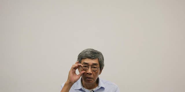 In this Sunday, June 19, 2016 photo, Hong Kong bookseller Lam Wing-kee reacts during an interview in Hong Kong. Hong Kong officials say there's little chance Lam, who is wanted in mainland China, would be sent back after mainland authorities threatened him with tougher punishment if he didn't return. (AP Photo/Vincent Yu)