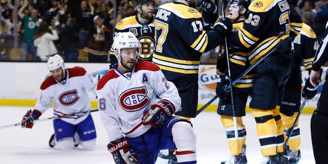 Montreal Canadiens defensemen Josh Gorges (26) and Mike Weaver, left, react as Boston Bruins defenseman Zdeno Chara (33), defenseman Torey Krug (47) and left wing Milan Lucic (17) celebrate a goal by right wing Jarome Iginla, left, during the second period in Game 7 of an NHL hockey second-round playoff series in Boston, Wednesday, May 14, 2014. (AP Photo/Elise Amendola)