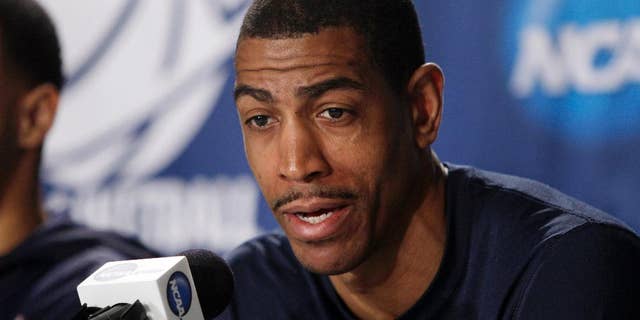 Connecticut head coach Kevin Ollie responds to a question during a news conference at the NCAA college basketball tournament Saturday, March 29, 2014, in New York. Connecticut plays Michigan State in a regional final on Sunday. (AP Photo/Frank Franklin II)