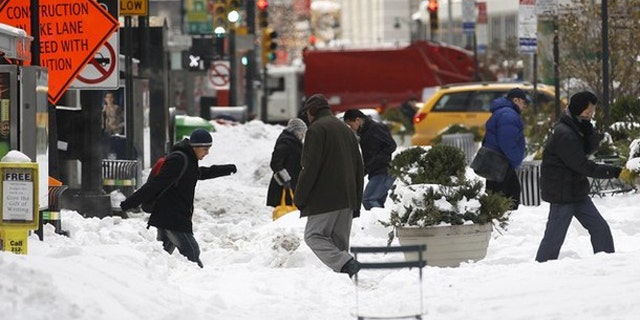 Dec. 28, 2010: Pedestrians cross a snow covered portion of Broadway in New York's Times Square (Reuters).