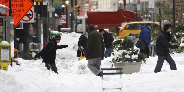 Dec. 28, 2010: Pedestrians cross a snow covered portion of Broadway in New York's Times Square (Reuters).