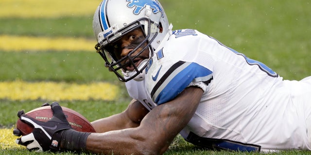 Detroit Lions wide receiver Calvin Johnson (81) lays in the end zone after making a touchdown catch in the first half of an NFL football game against the Pittsburgh Steelers in Pittsburgh, Sunday, Nov. 17, 2013. (AP Photo/Gene J. Puskar)