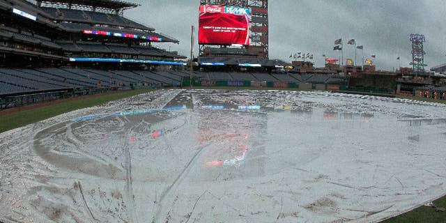 In this photo taken April 25, 2017, the rain tarp covers the infield of Citizens Bank Park in Philadelphia, where the Philadelphia Phillies baseball game against the Florida Marlins was postponed due to bad weather. That whole April showers thing went bit overboard last month in the U.S. The National Oceanic and Atmospheric Administration (NOAA) calculated that April 2017 was the country’s second wettest April on record, averaging 3.43 inches for the nation, nearly an inch above the 20th century average. Only 1957 had a slightly wetter April. Records go back to 1895. (AP Photo/Tom Mihalek)