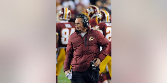 In this Sunday, Jan. 6, 2013, photo, Washington Redskins coach Mike Shanahan watches during the first half of an NFL wild card playoff football game against the Seattle Seahawks in Landover, Md. Shanahan has come under fire in the wake of Robert Griffin III reinjuring his right knee in Sunday's 24-14 wild-card loss to Seattle. The criticism has ranged from whether Shanahan cared enough for his sensational rookie to whether the natural protocol for dealing with injuries was followed. (AP Photo/Richard Lipski)