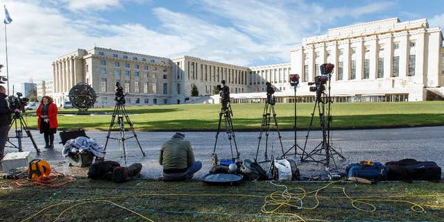 FILE - In this Monday, Feb. 1, 2016 file photo, reporters wait in front the UN building after Syria talks were rescheduled at the European headquarters of the United Nations in Geneva, Switzerland. A Taiwanese labor relations professor complained Wednesday, June 8, 2016 to the United Nations after a study group that she has regularly led was blocked from an International Labor Organization conference in Geneva. The episode highlights concerns about where and when China might seek to block Taiwanese interests in the international arena since independence-leaning President Tsai Ing-wen took office in Taiwan last month. (Salvatore Di Nolfi/Keystone via AP, file)