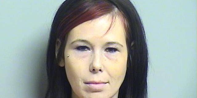FILE - This undated file booking photo released by Tulsa County Sheriff's Office shows Shaynna Sims. Sims who has been charged with slashing the corpse of her boyfriend's ex-girlfriend during a funeral viewing has been ordered to stand trial, a Tulsa judge ruled Friday, Sept. 11, 2015. (Tulsa County Sheriff's Office via AP, File)
