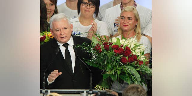 Jaroslaw Kaczynski, left, leader of the conservative opposition Law and Justice party announces victory in the general elections in Poland at the party's headquarters in Warsaw, Poland, on Sunday, Oct.25, 2015. The victory of his Eurosceptic party ends eight years in power of pro-EU, pro-business Civic Platform which voters accuse of being conformist, detached and focused on power rather than on improving the living in Poland.(AP Photo/Czarek Sokolowski)