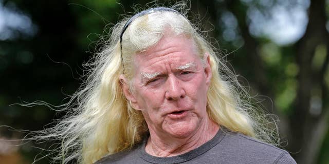FILE- In this Aug. 11, 2016 file photo, Mickey Munday talks to a reporter in Love Park in North Miami, Fla. Munday, a former pilot for Colombia's Medellin cartel during Miami's "cocaine cowboy" years was indicted Thursday, May 4, 2017, along with seven others from Florida and Missouri in a complex automobile fraud scheme. (AP Photo/Alan Diaz, File)