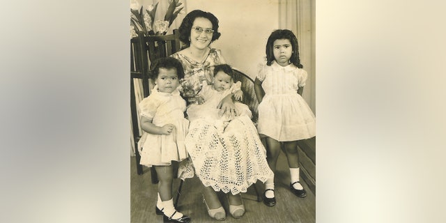 In this undated photo courtesy of Michelle Faul, Ethel Pillay is shown with her daughters, from left, Carole, Danette and Michelle, who experienced South Africa’s apartheid system when they traveled there to visit relatives. Associated Press Chief Africa Correspondent Michelle Faul described how on one trip, after a 15-hour drive, a gas station refused to hand over the keys to the toilet to her mother because it was for whites only. Nelson Mandela fought to bring down the institutionalized code that made blacks subhuman. (AP Photo/Courtesy of Michelle Faul)